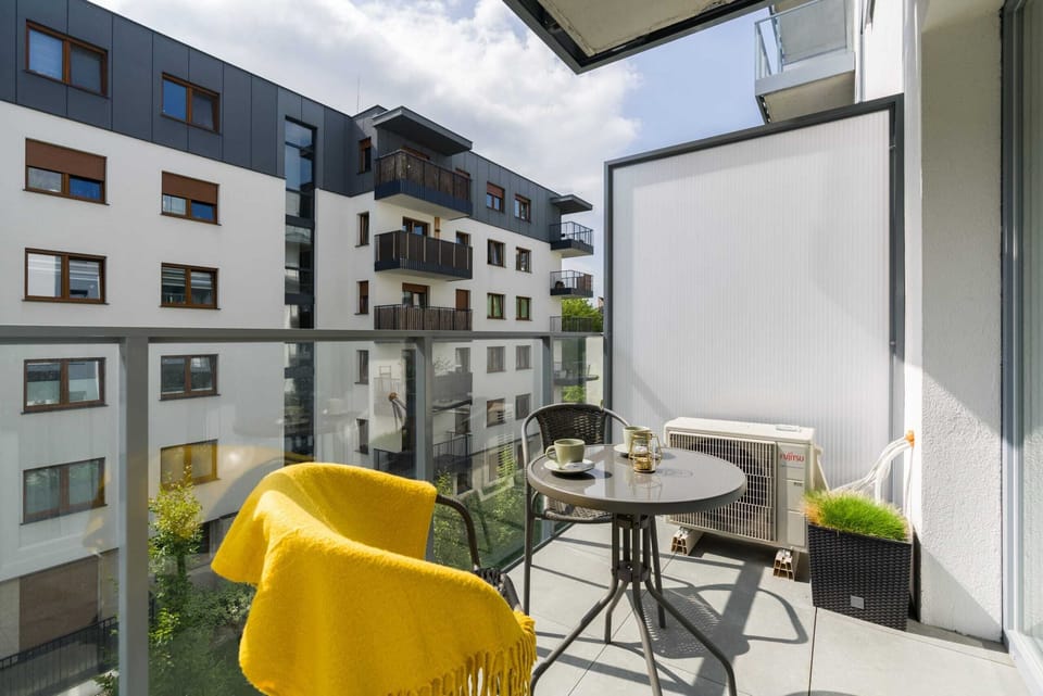 The furnished balcony offers a perfect spot for morning coffee with a view.