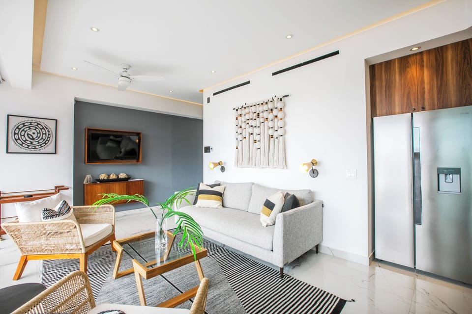 Settle into your inviting living space where natural wood accents and plush seating create the perfect atmosphere for relaxation. With a fully-equipped kitchen and thoughtful touches throughout, you'll feel right at home.