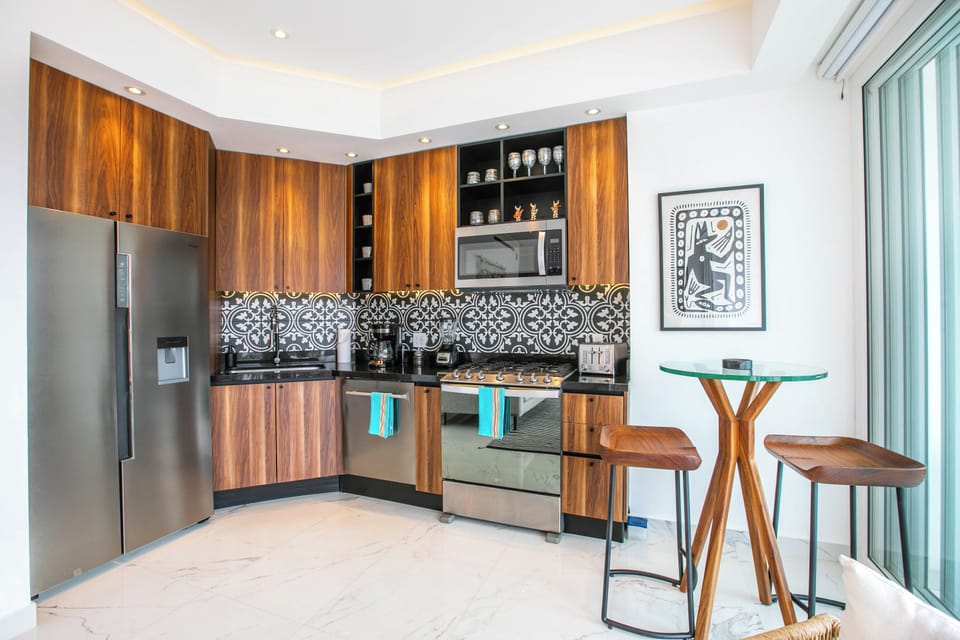 Your fully equipped kitchen features rich wood cabinetry, modern appliances, and stunning tilework—everything you need to whip up meals in style during your stay.
