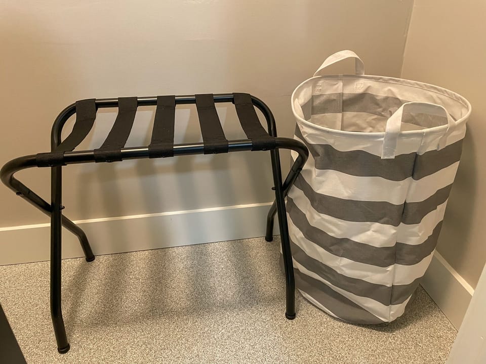 suitcase racks and laundry baskets provided