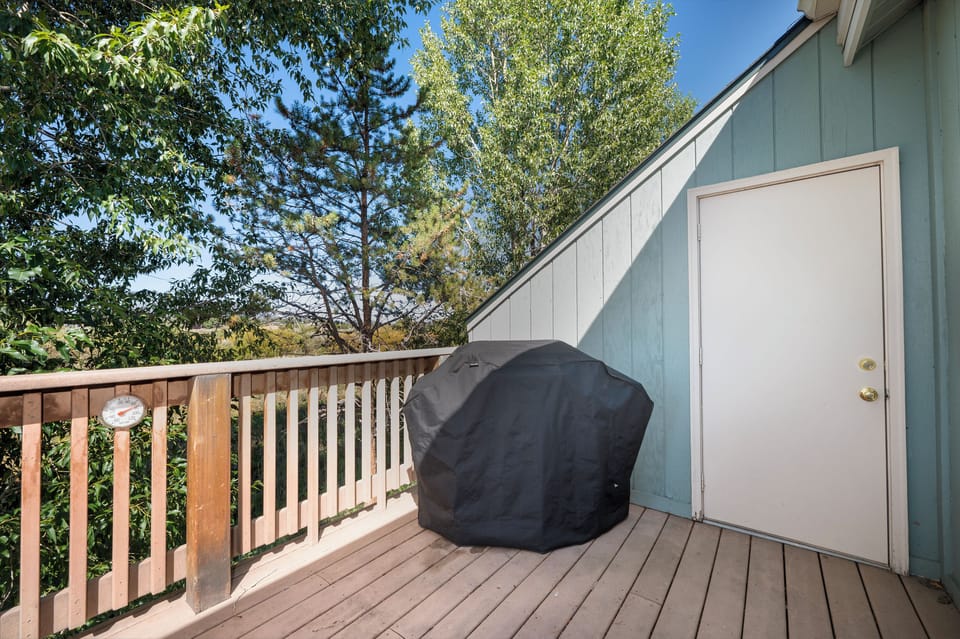 Private deck overlooking peaceful trees offers your perfect retreat with BBQ ready for memorable outdoor dining moments.