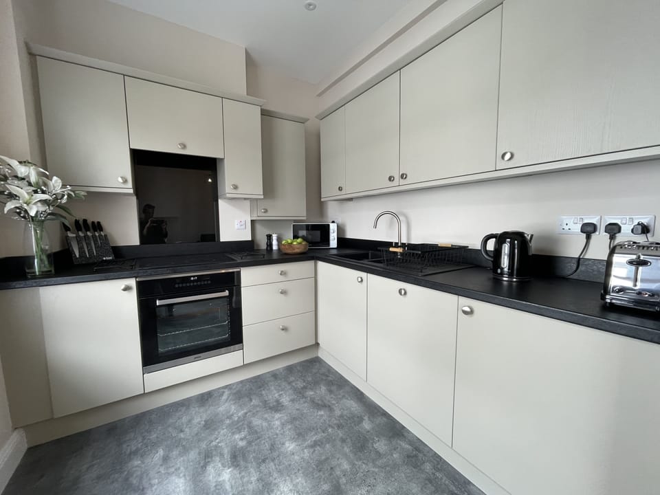Fully equipped kitchen consists of an oven, electric hob, dishwasher, fridge with freezer box and plenty of crockery and cookware.