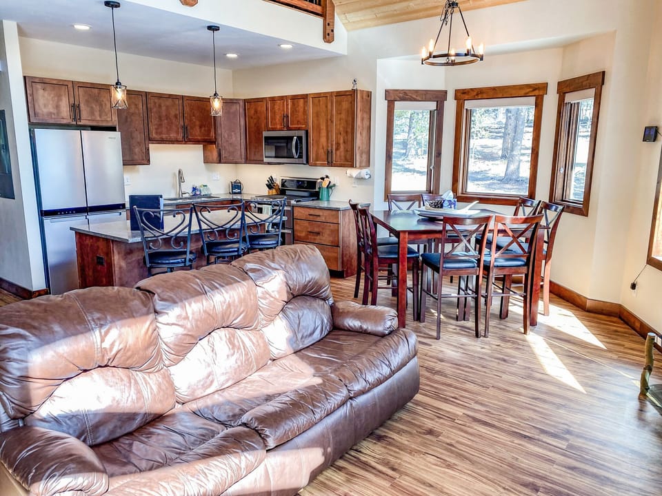 Enjoy comfortable seating around the large stone hearth of the wood burning fireplace and the 48 inch Smart TV