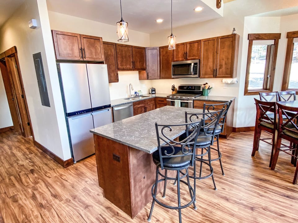 The kitchen opens into the great room and has a great island to grab a snack or socialize with others in the area