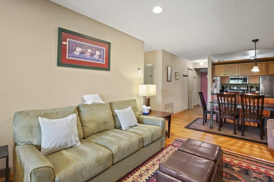 The plush couch doubles as a queen-size pull out bed while the ottomans make it easy to kick back and unwind. The living area is also open to the dining area and kitchen by way of a convenient pass-through.