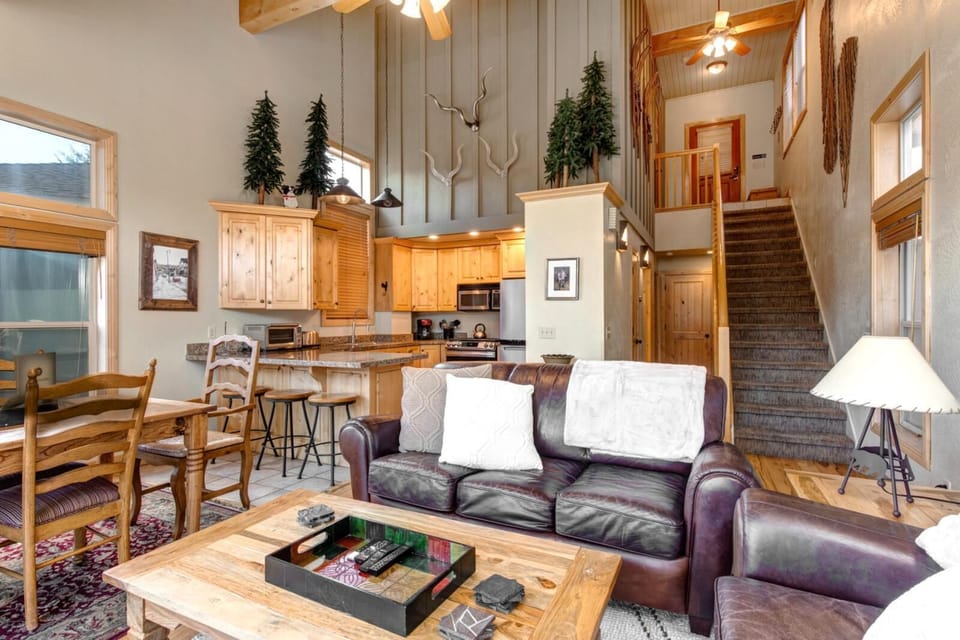 Relax by the fire in this warm and welcoming living space, where the vaulted ceiling opens up to the kitchen and dining area.