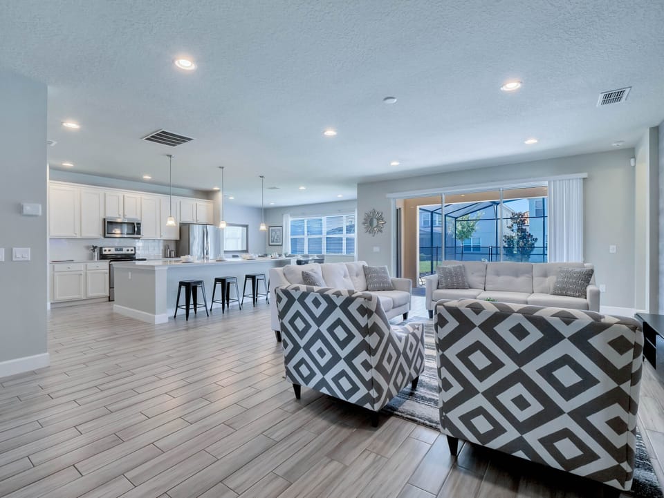 - Open living room with cozy seating and smart TV  
- Bright vacation rental near Disney with pool access  
- Perfect family gathering space with modern décor