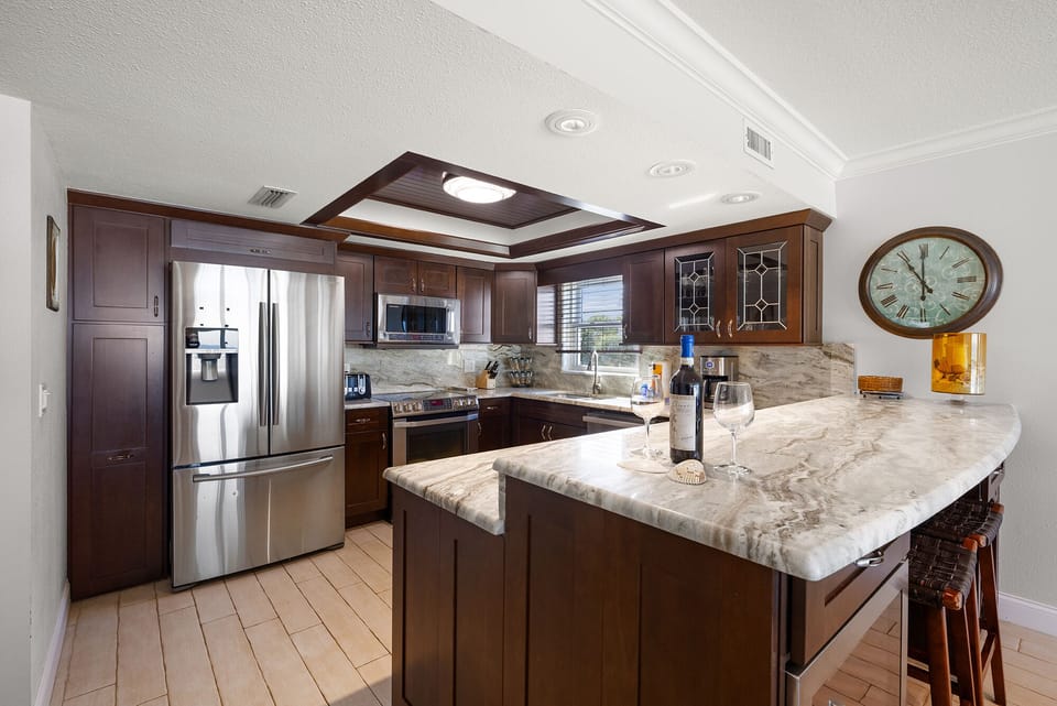 stainless steel appliances–granite countertops–recessed lighting–tray ceiling