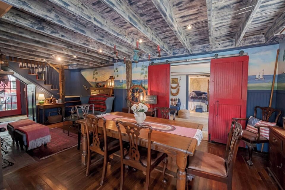 Off the Keeping Room behind the red barn doors is the 1st-floor Cordage Guest Room suite (includes a  sitting area with a private bathroom). The doors slide closed to this bedroom. 