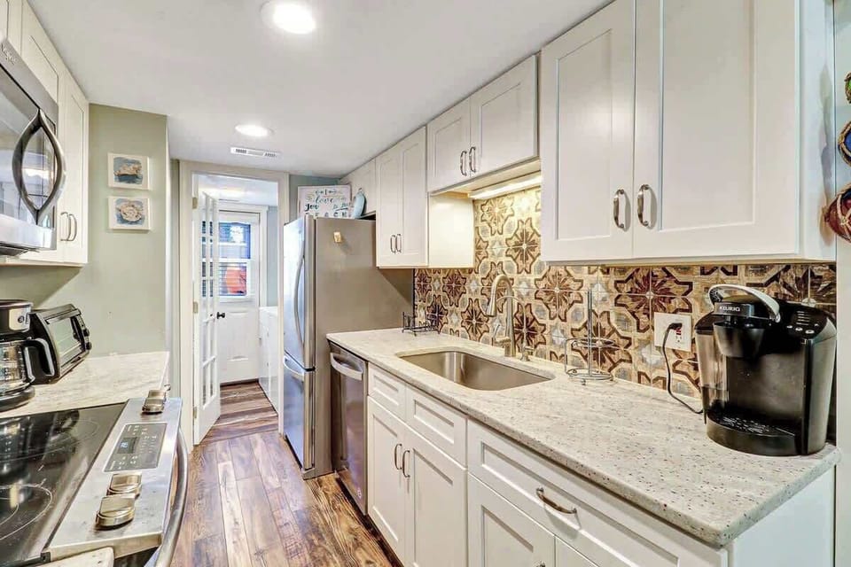 Upgraded kitchen with granite countertops and stainless steel appliances
