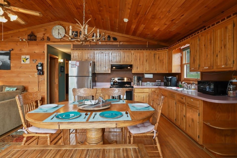 Fully stocked kitchen with pots and pans, plates, silverware, and a spice rack!