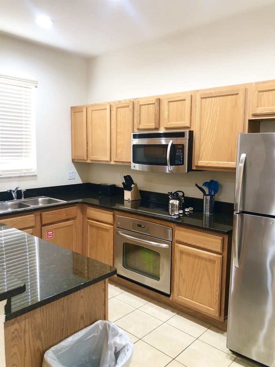 Spacious kitchen with stainless appliances and solid surface countertops