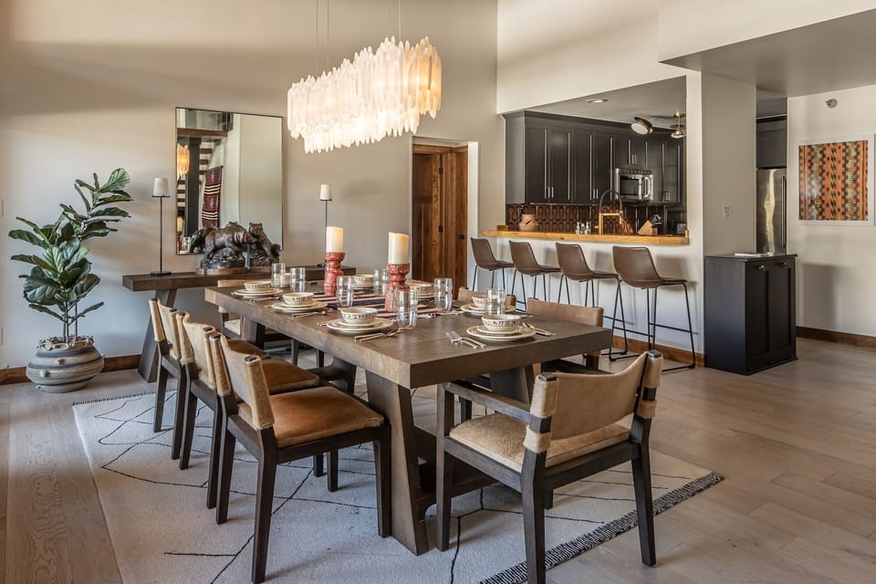 Your elegant dining space flows seamlessly into the modern kitchen, perfect for memorable meals together under the stunning statement chandelier.