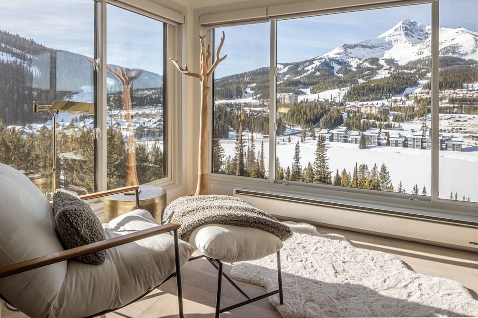 Curl up in your cozy reading nook while soaking in breathtaking mountain vistas through floor-to-ceiling windows.
