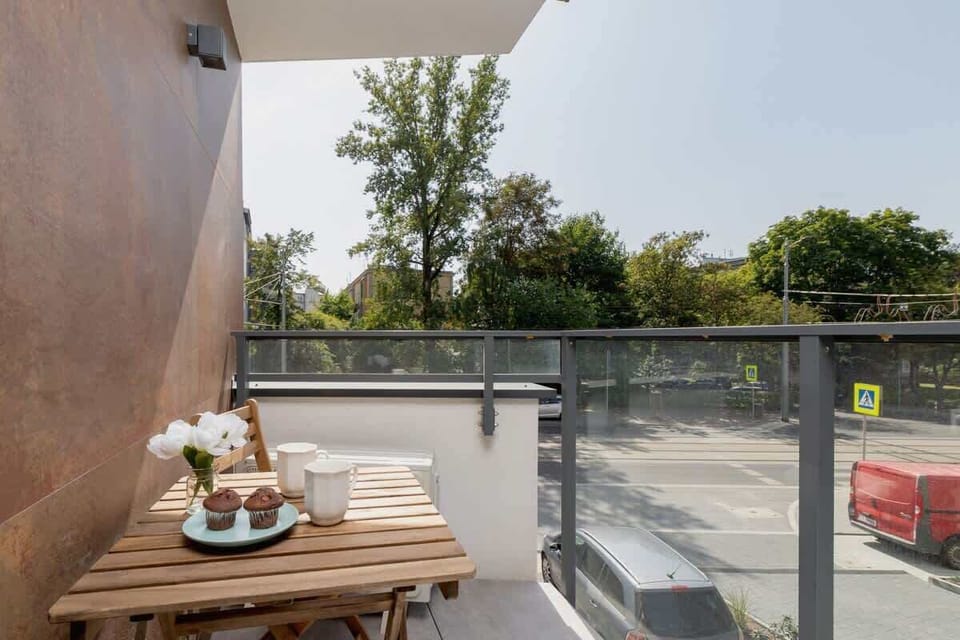 The balcony's stylish design complements the apartment's decor. 