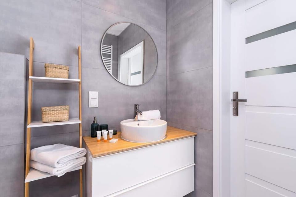 The bathroom's contemporary decor complements the apartment's style. 