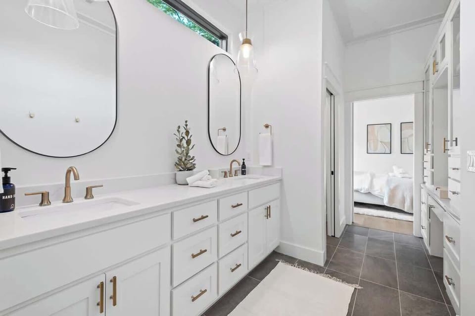 The first Primary bath has double sinks, a tiled shower and tons of counter space.