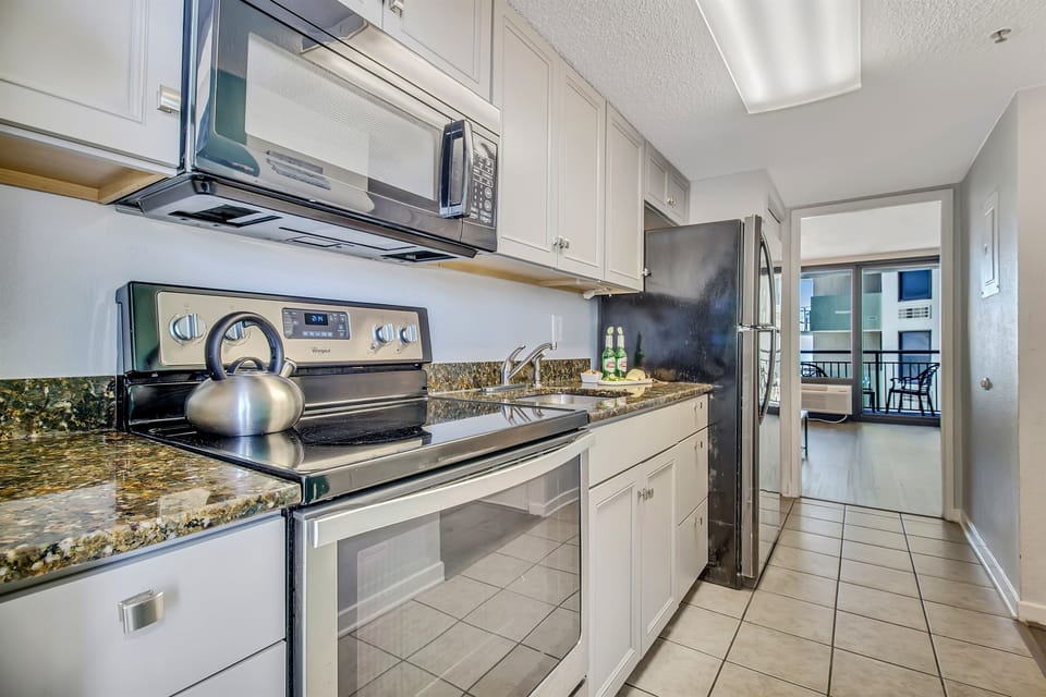 Step into our suite's kitchen, a gourmet haven equipped with modern appliances, sleek countertops, and everything you need to whip up a culinary masterpiece!