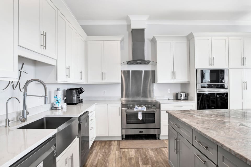 Fully equipped kitchen with dual appliances and stone counters