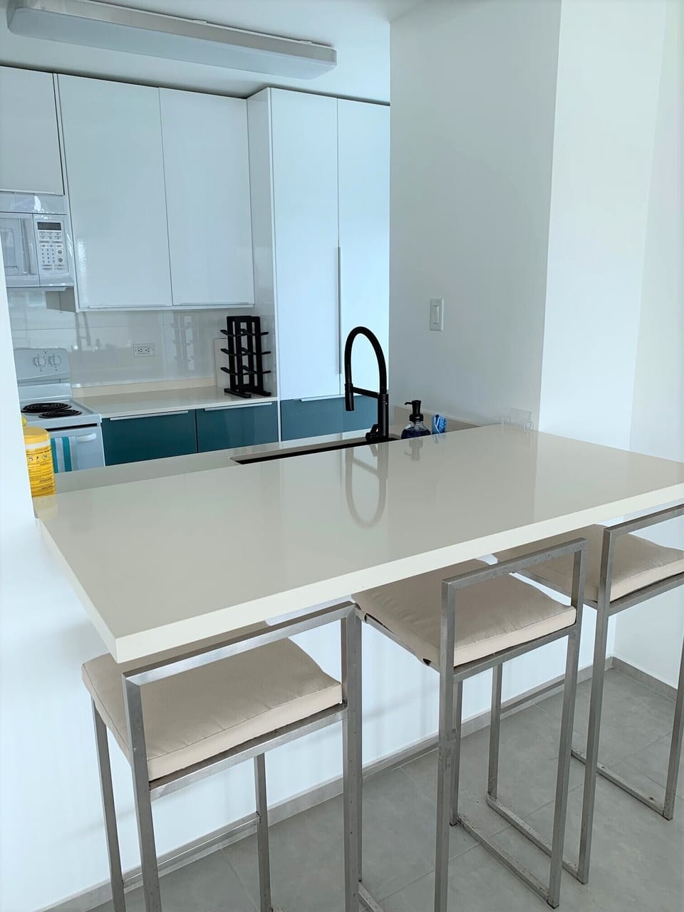 Countertop w/3 high stools by the kitchen