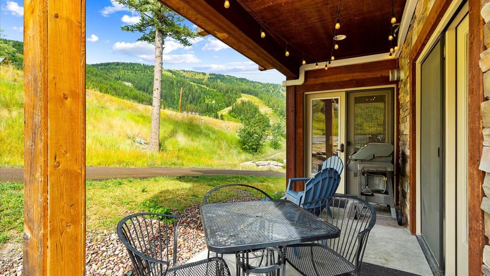 Outdoor patio features a gas grill (propane provided), and seating area for 2 and outdoor dining table for 5.