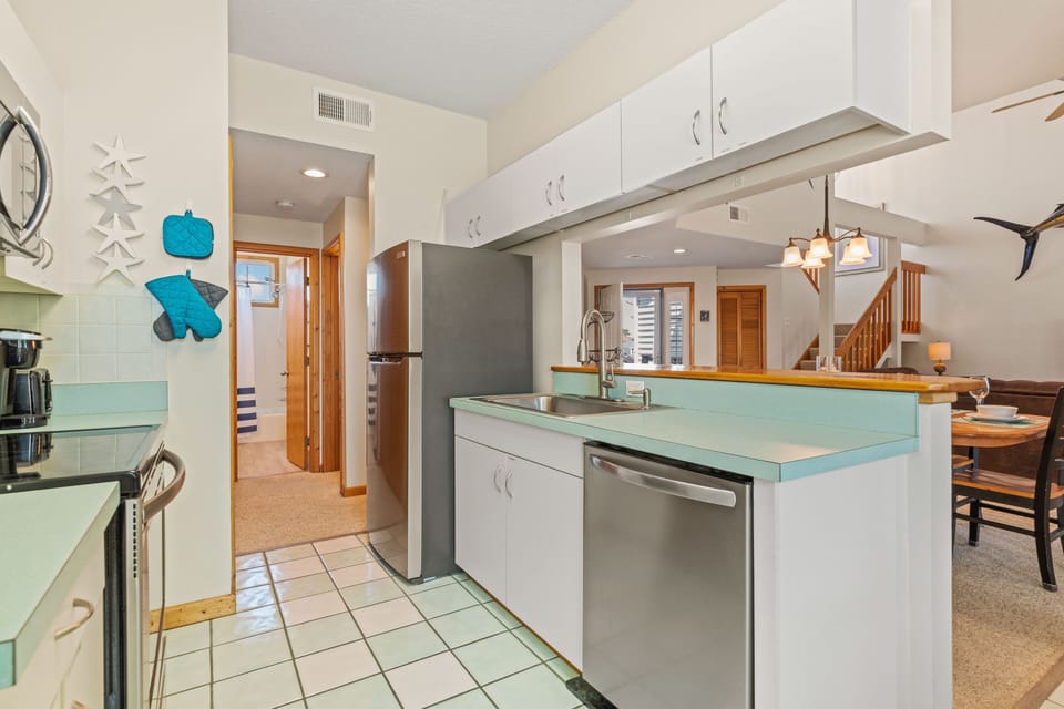 Kitchen with stainless appliances &  pass through to dining area