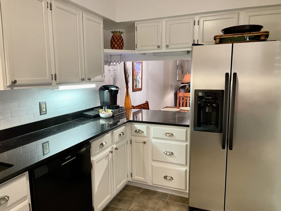 Granite counters & refrigerator with filtered water and ice maker.