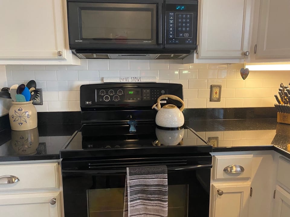 Electric stove and microwave, plenty of supplies.