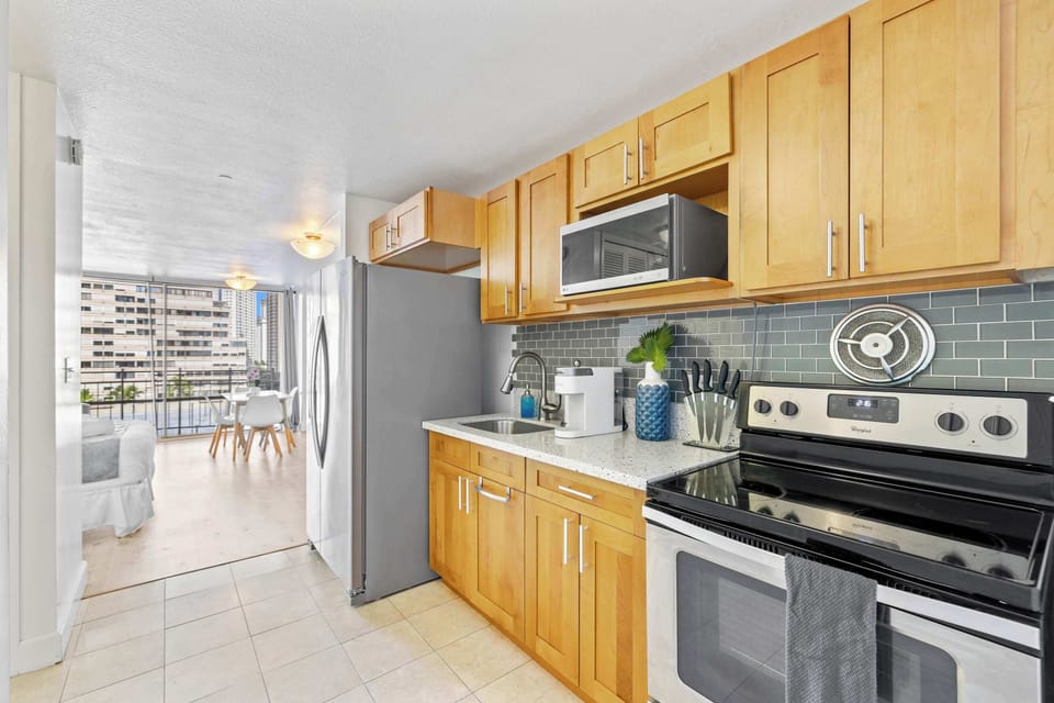 Modern kitchen with basic appliances, sleek counters, and stylish cabinetry