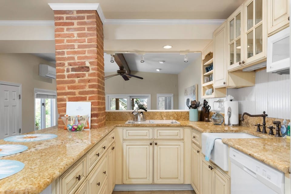 The kitchen is fully-stocked with cookware, plates, silverware and glasses.