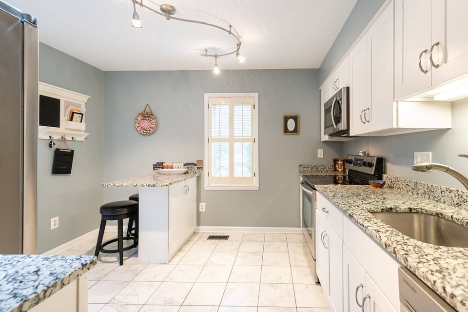 The kitchen is fully stocked with cookware and dinnerware to prepare a gourmet meal.