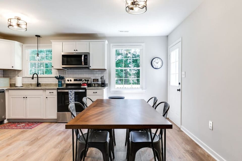 Gather for meals or conversations at the dining table with seating for four, conveniently located in the heart of the home.