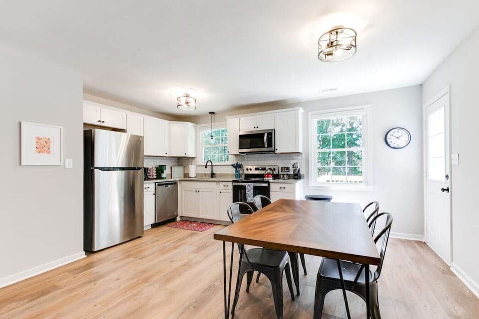 Gather for meals or conversations at the dining table with seating for four, conveniently located in the heart of the home.