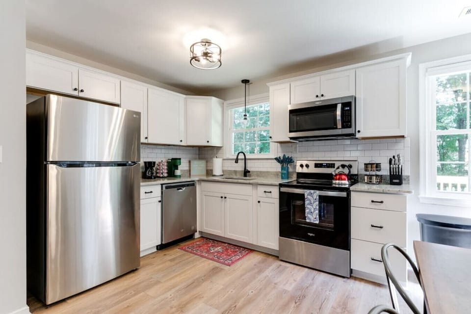 Cook with ease in this bright, well-stocked kitchen featuring a dishwasher, microwave, spice rack, and a coffee station with both drip and Keurig options.
