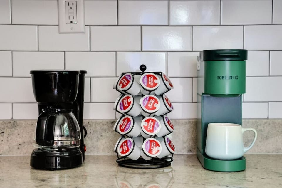 Cook with ease in this bright, well-stocked kitchen featuring a dishwasher, microwave, spice rack, and a coffee station with both drip and Keurig options.