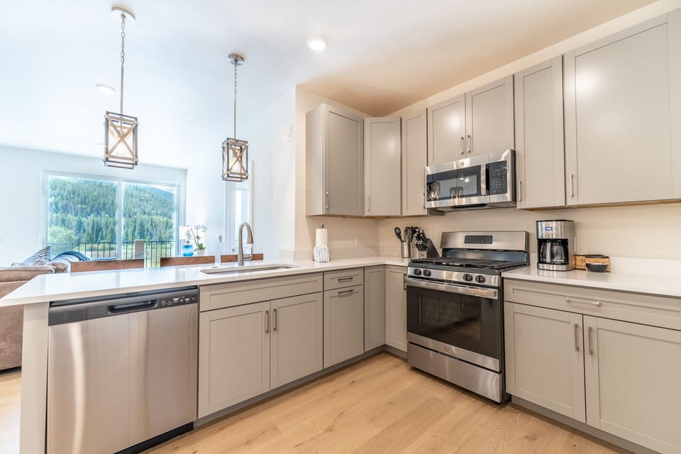 Your fully equipped kitchen features modern appliances and stunning mountain views while you cook.