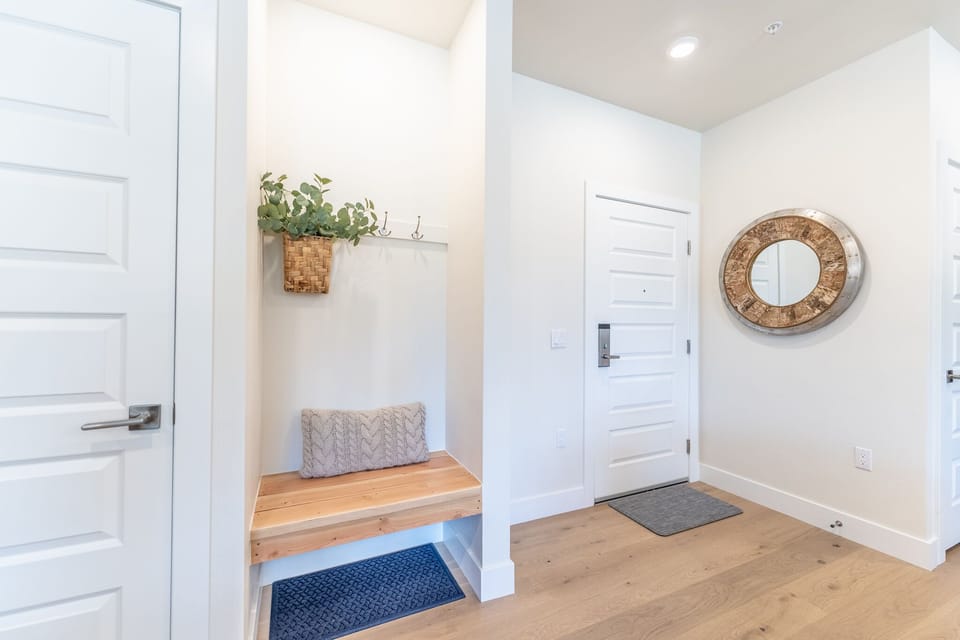 Step into your bright, welcoming entryway featuring a cozy built-in bench perfect for settling in after exploring the area.