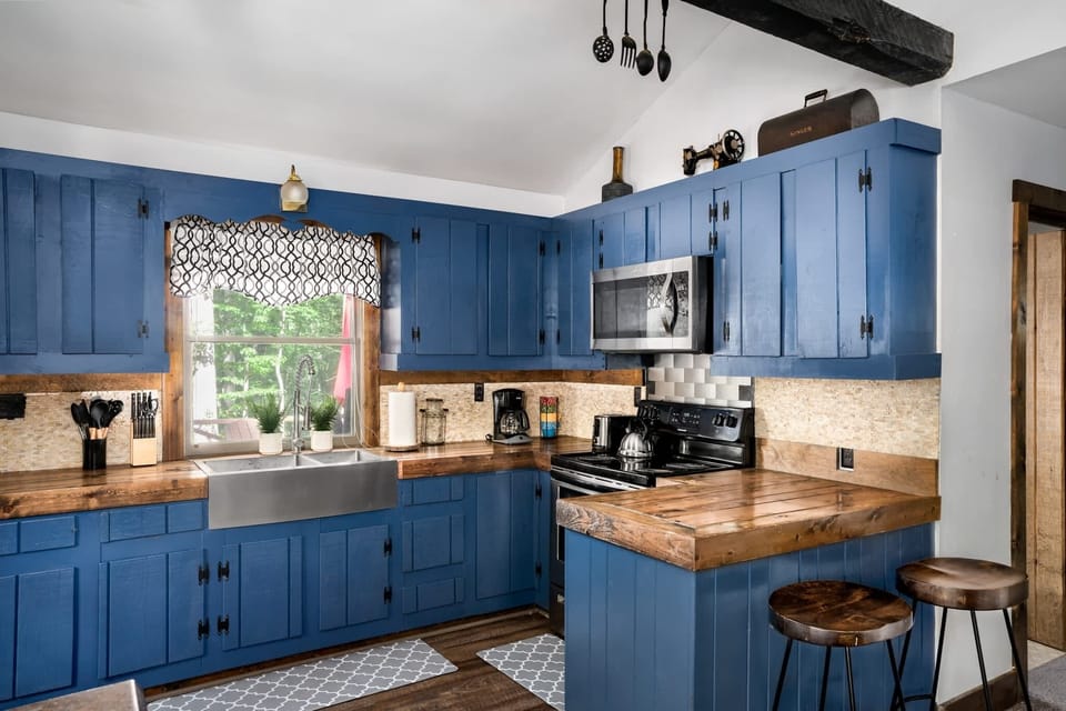 Fully-stocked kitchen with a stove/oven, and microwave