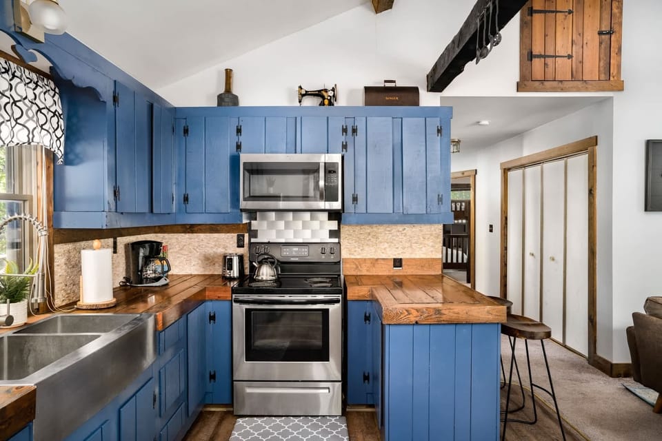 Fully-stocked kitchen with a stove/oven, and microwave