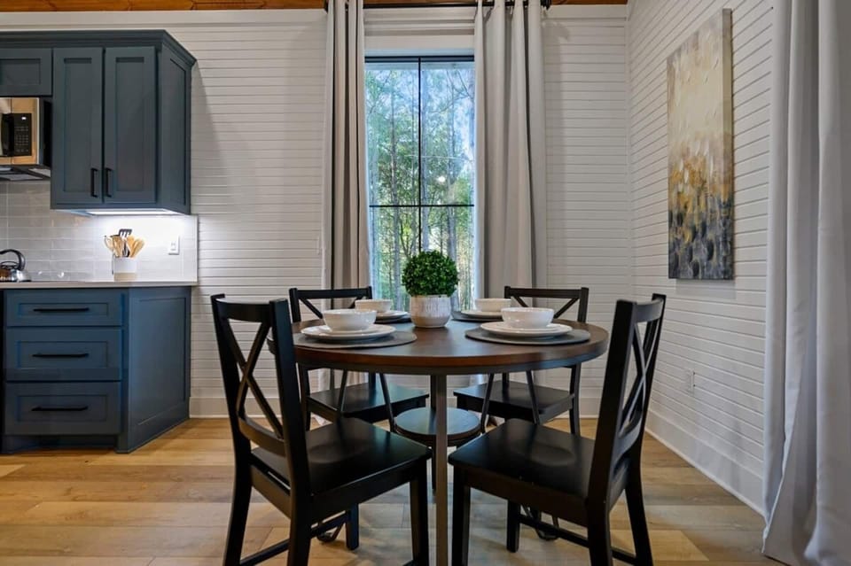 Dine together — the dining table seats the whole crew, steps from the kitchen and fireplace glow.
