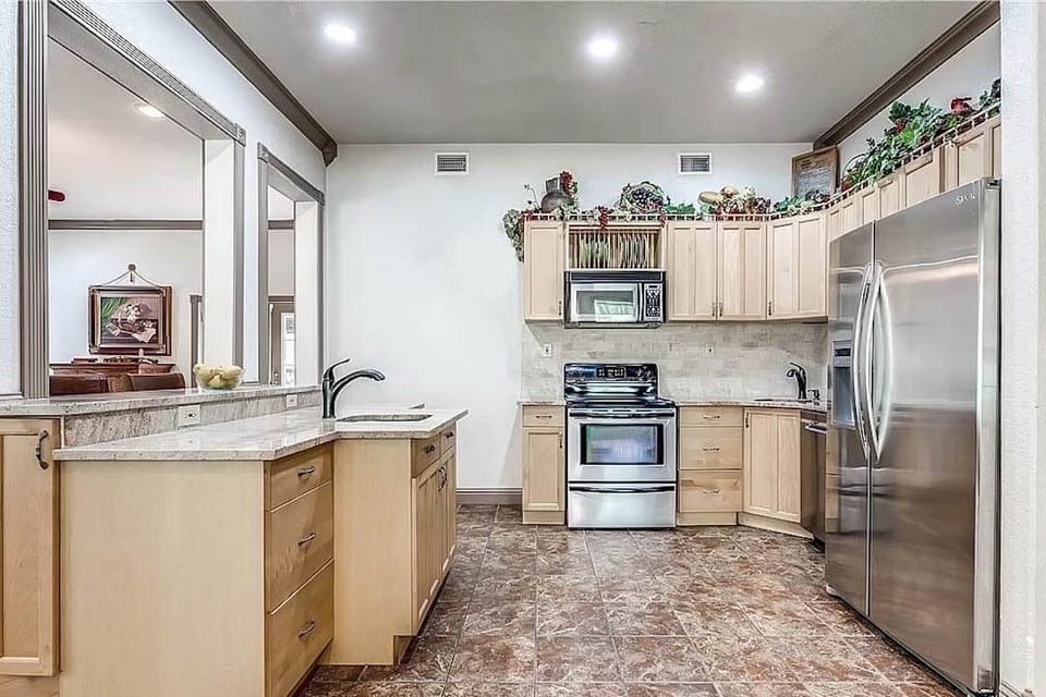 Full kitchen with oven, stove, pots/pans, dishwasher, plates, silverware etc