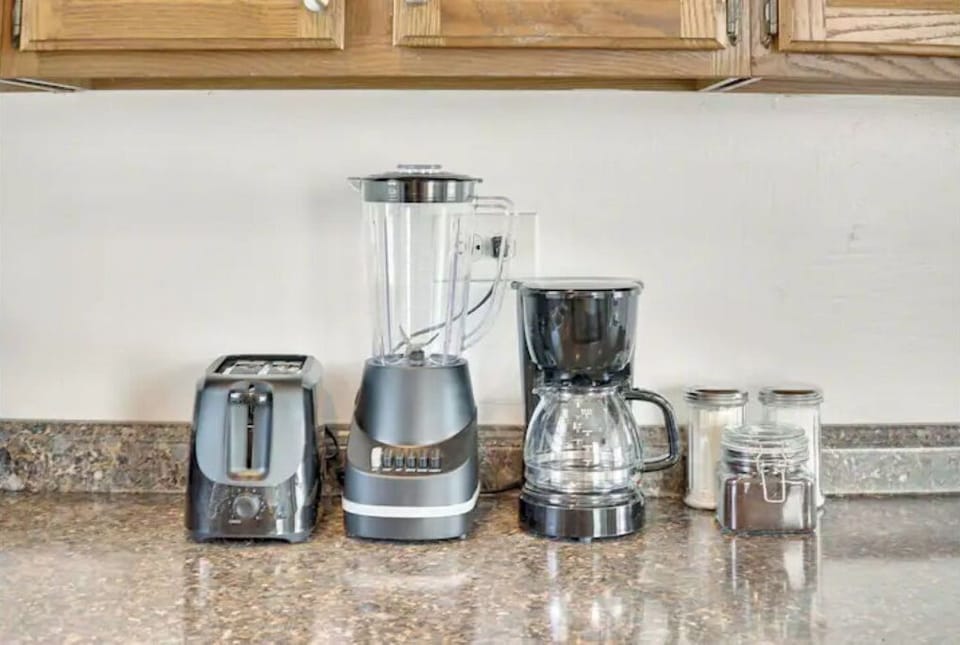 Fully equipped kitchen with fridge, oven, blender, microwave, and more.