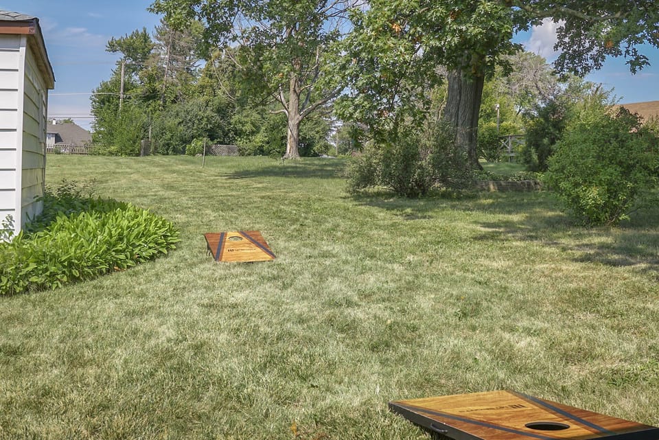 Spacious back patio with grill and cozy fire pit for outdoor fun.