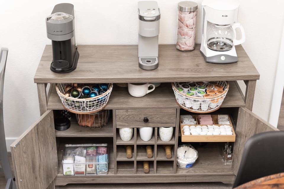 Fully stocked coffee and tea bar with hot chocolate, sugars, honey, and more
