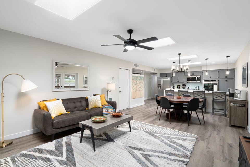 Open living and kitchen area with beautiful unique sky lights. Lots of seating. 