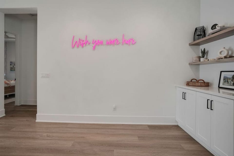 Entry space w/ shelving & neon accent, adding a fun welcoming touch