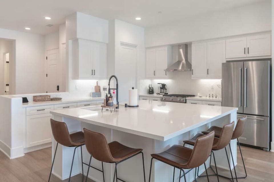 Sleek kitchen w/ spacious island seating, perfect for casual meals & conversation