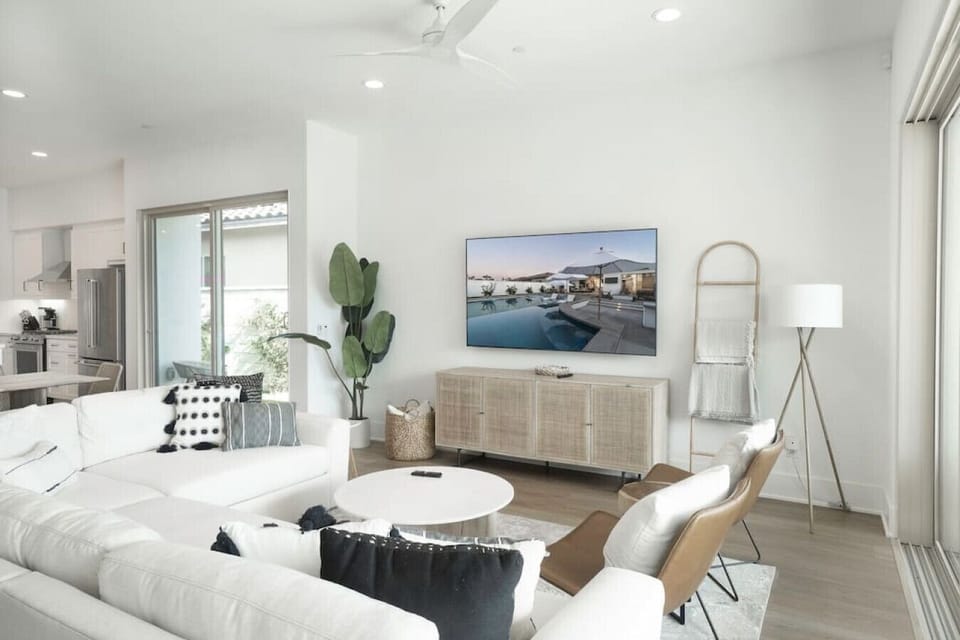 Airy living space w/ plush seating, natural light & clean, modern design
