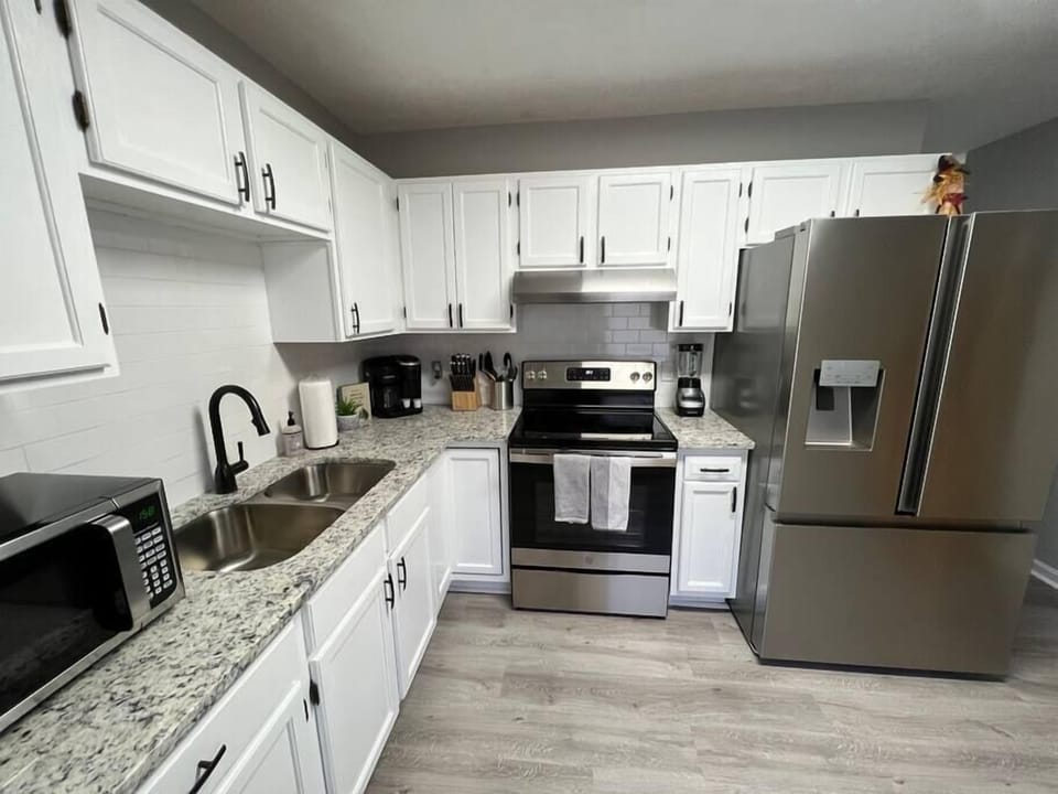 Brand new kitchen with granite countertops and high quality stainless steel appliances.