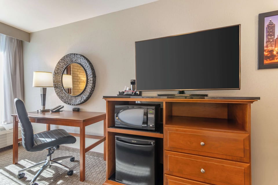 Desk, laptop workspace, blackout drapes, iron/ironing board